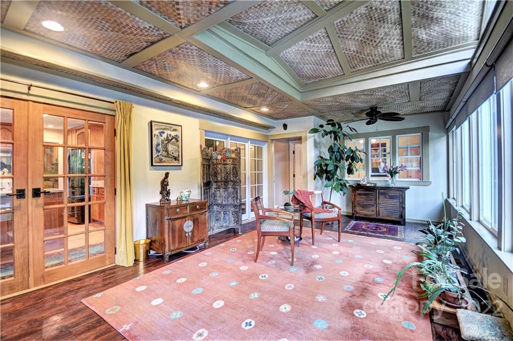 11 Echo Lake Drive Fairview, NC 28730 - Photo 26 of 48 a living room with furniture a fireplace and large windows