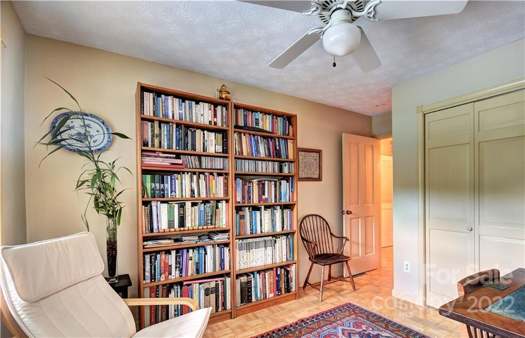 11 Echo Lake Drive Fairview, NC 28730 - Photo 32 of 48 a living room with furniture and a book shelf