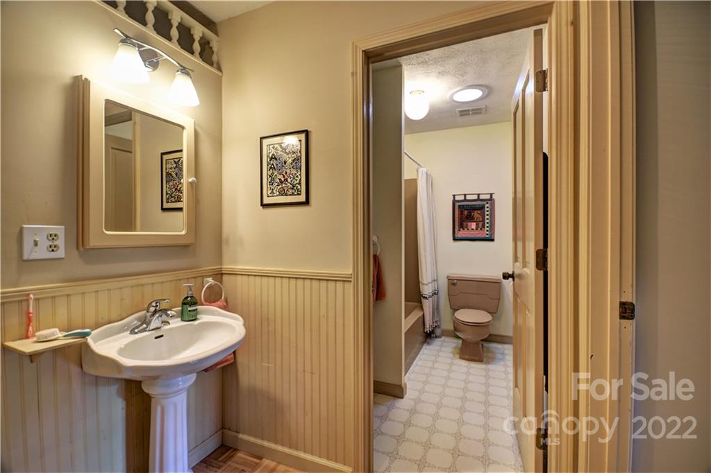 11 Echo Lake Drive Fairview, NC 28730 - Photo 34 of 48 a bathroom with a sink and a mirror