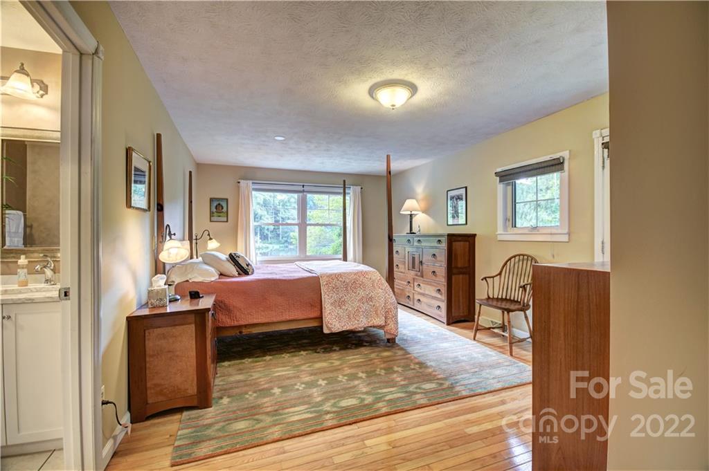 11 Echo Lake Drive Fairview, NC 28730 - Photo 38 of 48 a bedroom with a bed and wooden floor