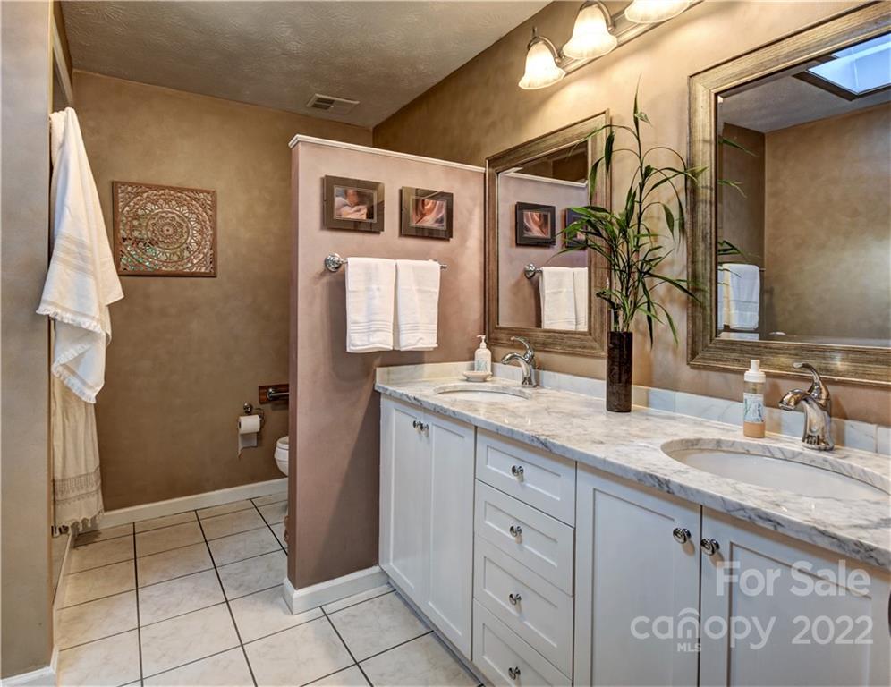 11 Echo Lake Drive Fairview, NC 28730 - Photo 40 of 48 a spacious bathroom with a granite countertop sink a mirror and a