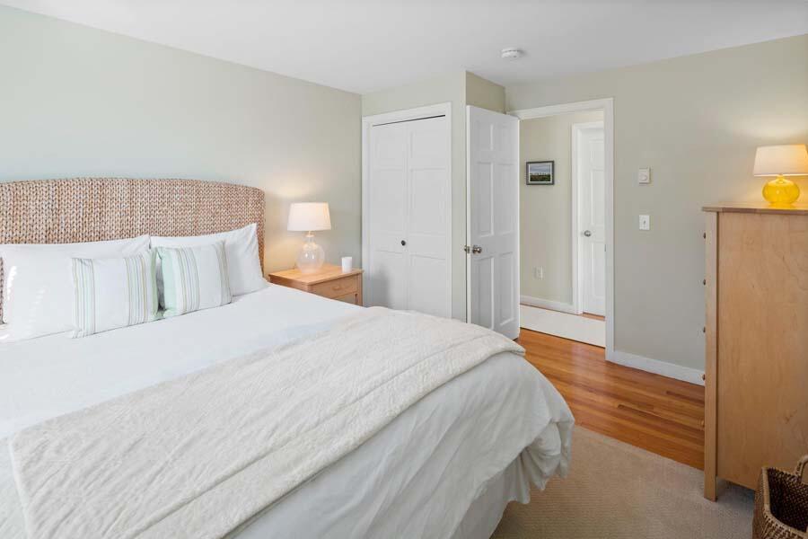 596 Shore Road, Unit 3 Truro, MA 02666 - Photo 13 of 37 a bedroom with a bed and wooden floor