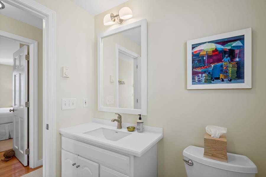 596 Shore Road, Unit 3 Truro, MA 02666 - Photo 14 of 37 a bathroom with a toilet a sink and mirror
