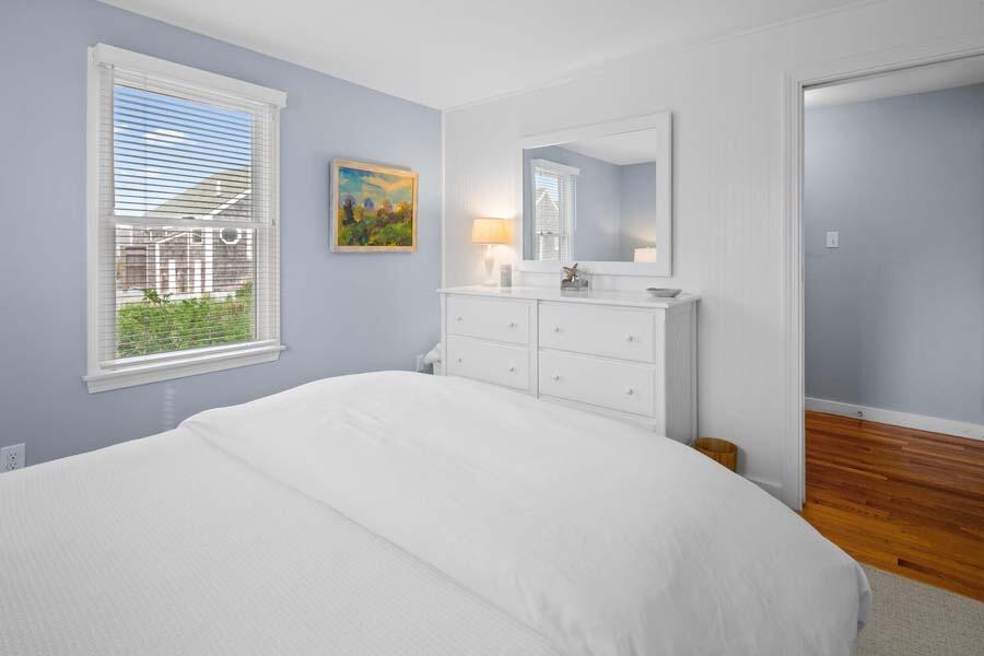 596 Shore Road, Unit 3 Truro, MA 02666 - Photo 17 of 37 a bedroom with a bed and a window