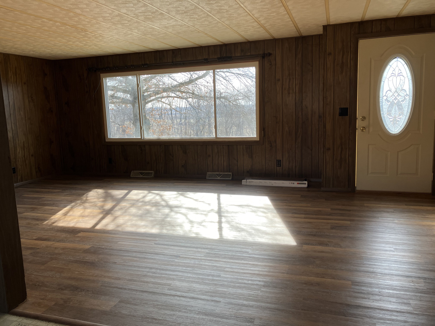 20040 Acker Road Fulton, IL 61252 - Photo 4 of 27 a view of empty room with wooden floor and fan