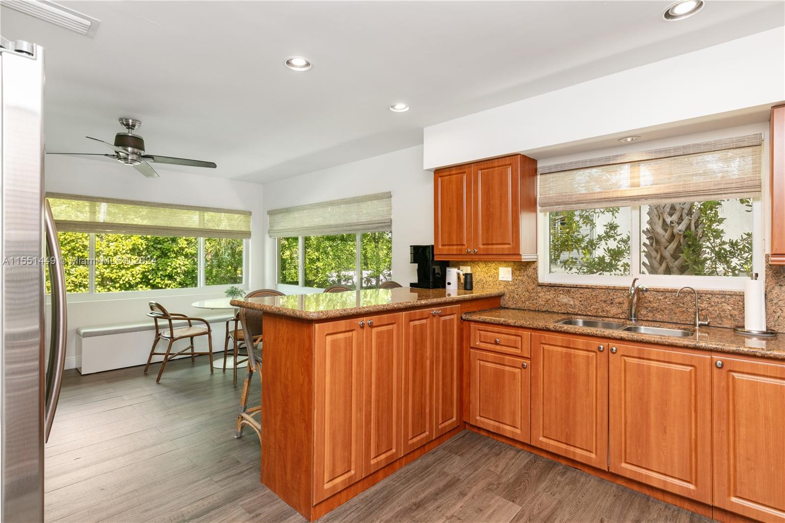 412 Ridgewood Road Key Biscayne, FL 33149 - Photo 21 of 47 a kitchen with stainless steel appliances granite countertop sink stove and wooden cabinets