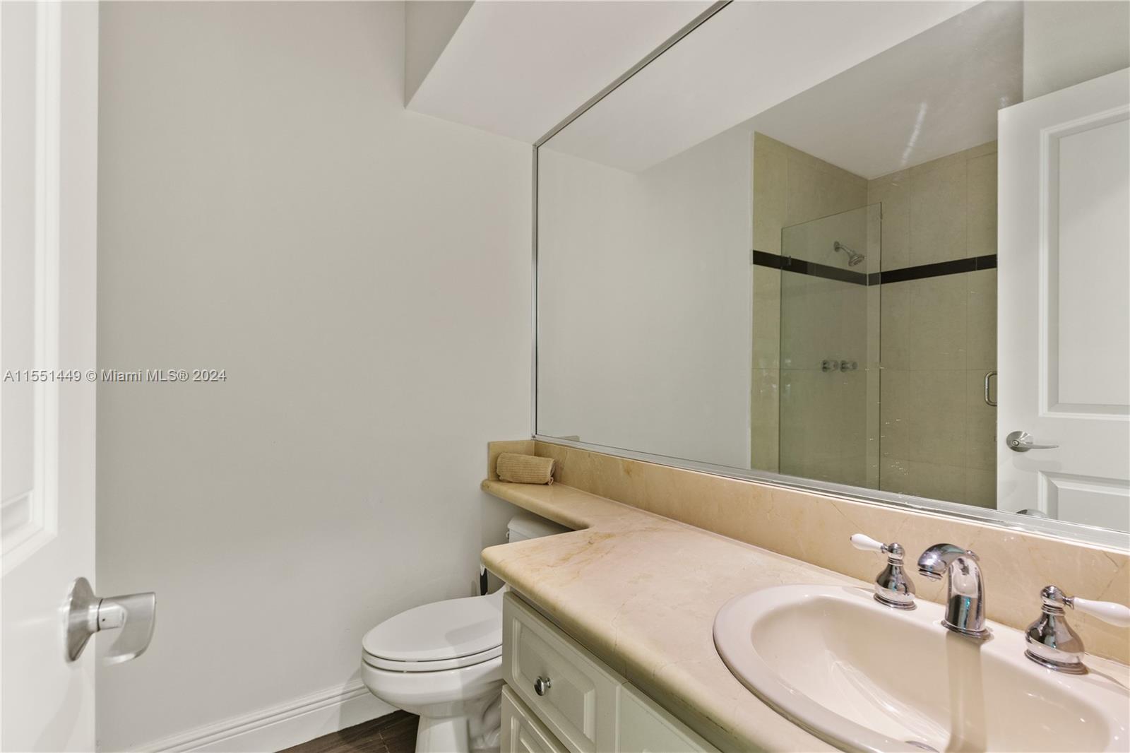 412 Ridgewood Road Key Biscayne, FL 33149 - Photo 30 of 47 a bathroom with a sink toilet and a mirror