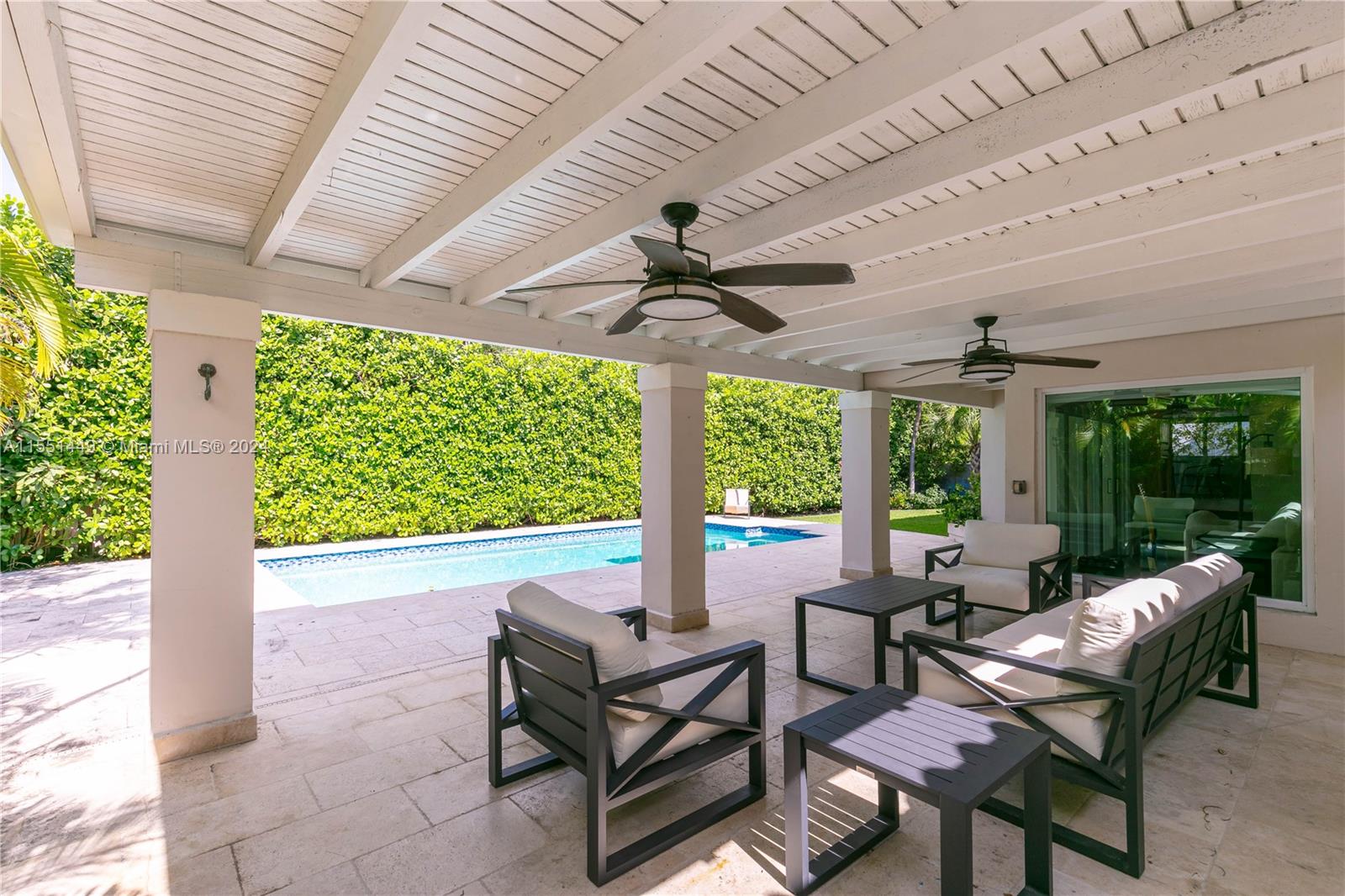412 Ridgewood Road Key Biscayne, FL 33149 - Photo 39 of 47 a living room with patio furniture and a floor to ceiling window