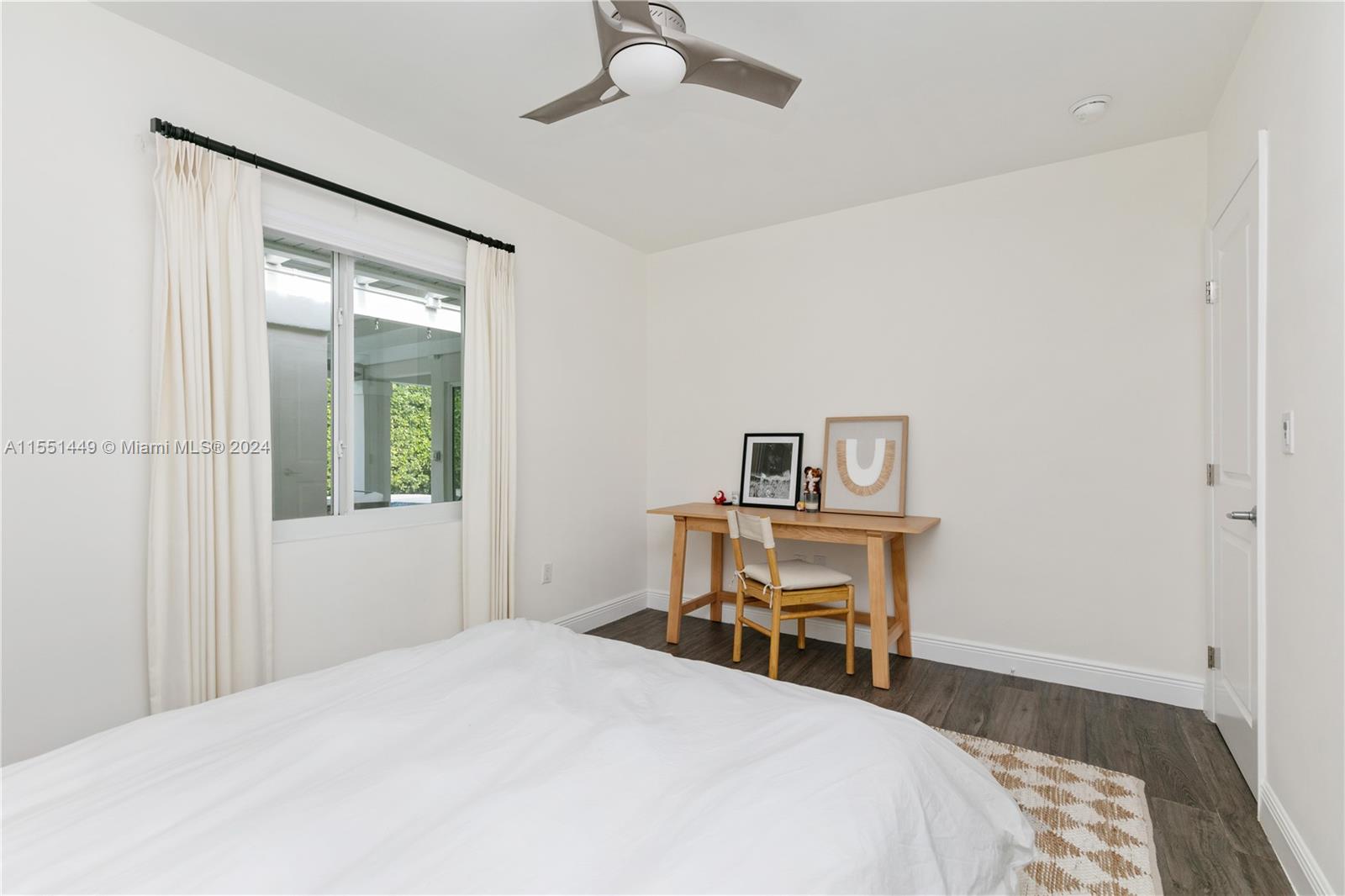 412 Ridgewood Road Key Biscayne, FL 33149 - Photo 7 of 47 a bedroom with a bed and a table in it