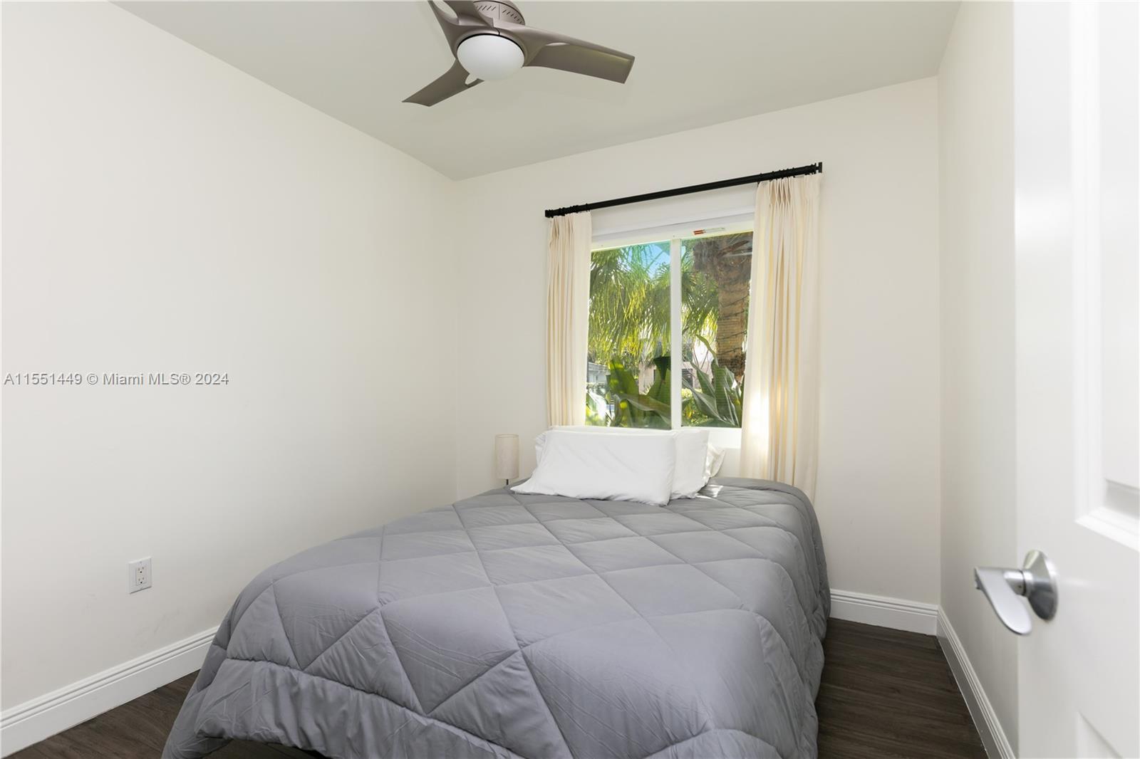 412 Ridgewood Road Key Biscayne, FL 33149 - Photo 10 of 47 a bedroom with a bed and a window