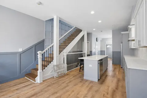 a view of kitchen and hall with wooden floor