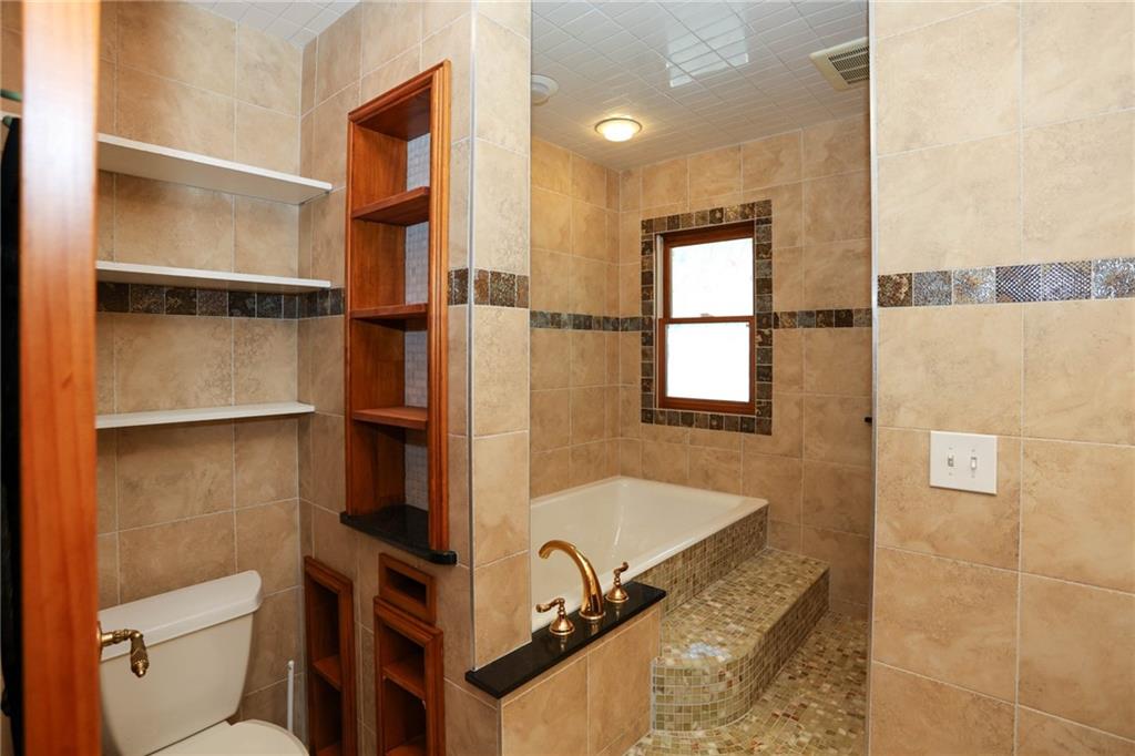 3602 Jones Mill Road Peachtree Corners, GA 30360 - Photo 17 of 35 a bathroom with a granite countertop sink toilet and shower