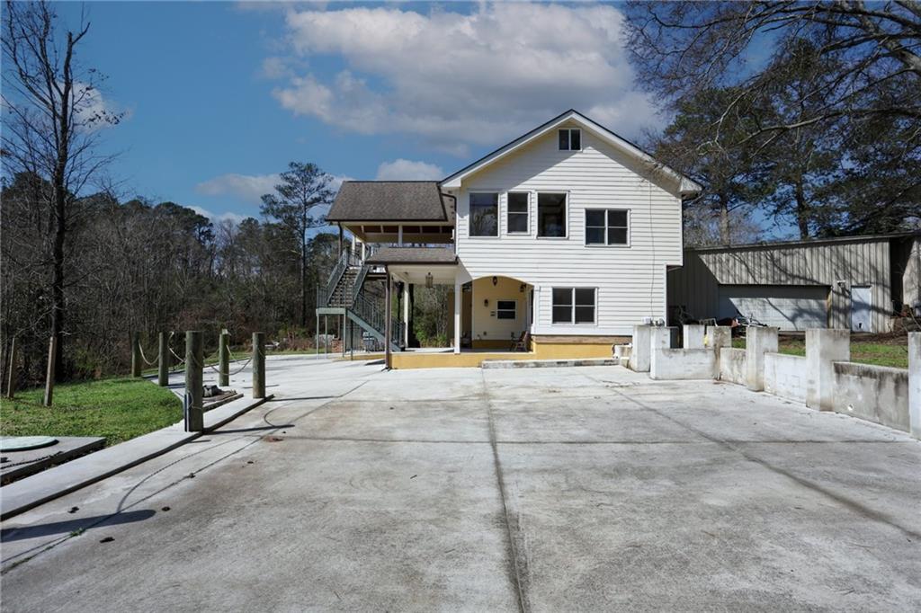 3602 Jones Mill Road Peachtree Corners, GA 30360 - Photo 28 of 35 a view of a white house with a yard and table and chairs