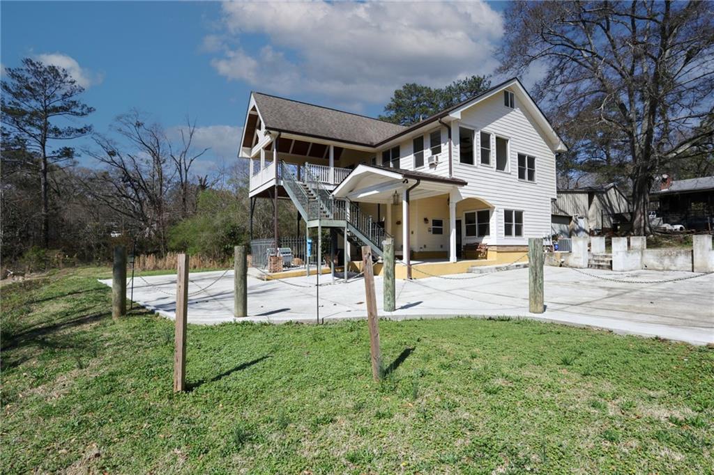 3602 Jones Mill Road Peachtree Corners, GA 30360 - Photo 29 of 35 a view of a white house with a yard and a bench