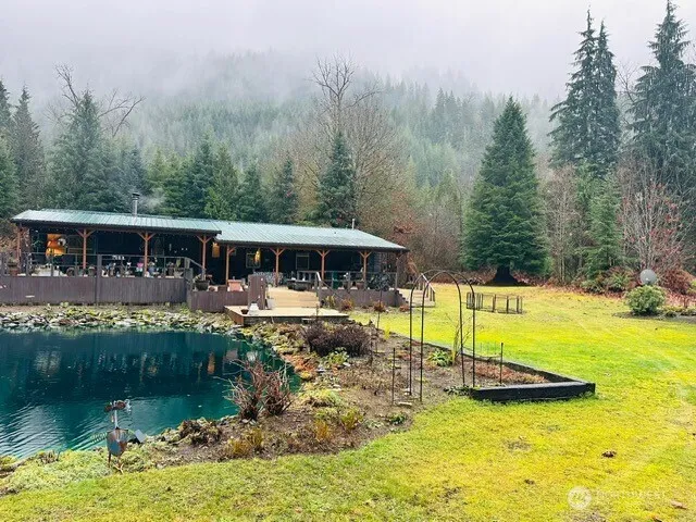 a view of a house with swimming pool and sitting area