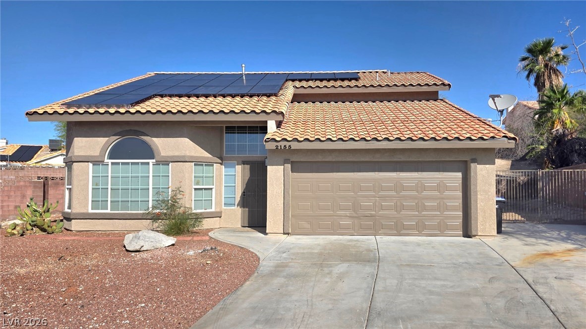 2155 Athol Way Laughlin, NV 89029 - Photo 2 of 19 Sun-drenched desert dwelling with a terracotta tile roof and efficient solar panels.