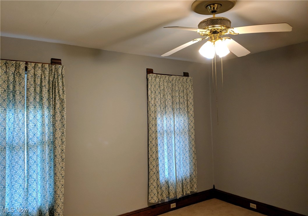 70 Center Road Bedford, OH 44146 - Photo 9 of 18 1st floor unit Spare room featuring carpet flooring and ceiling fan