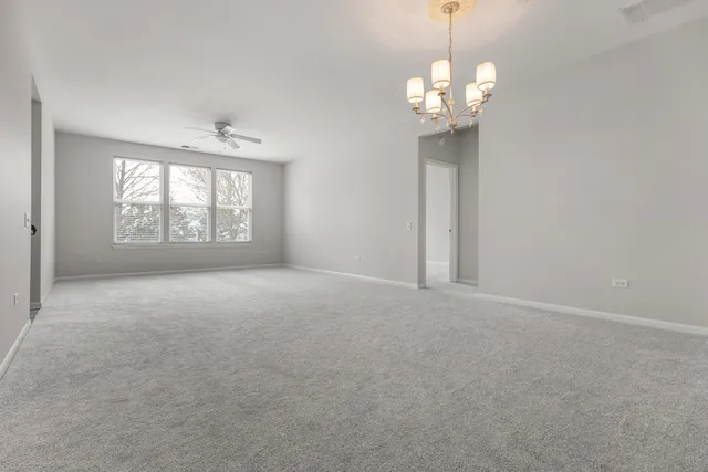 a view of a room with windows and chandelier