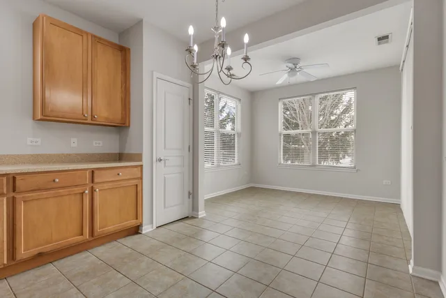 a view of a kitchen with an empty space and a window