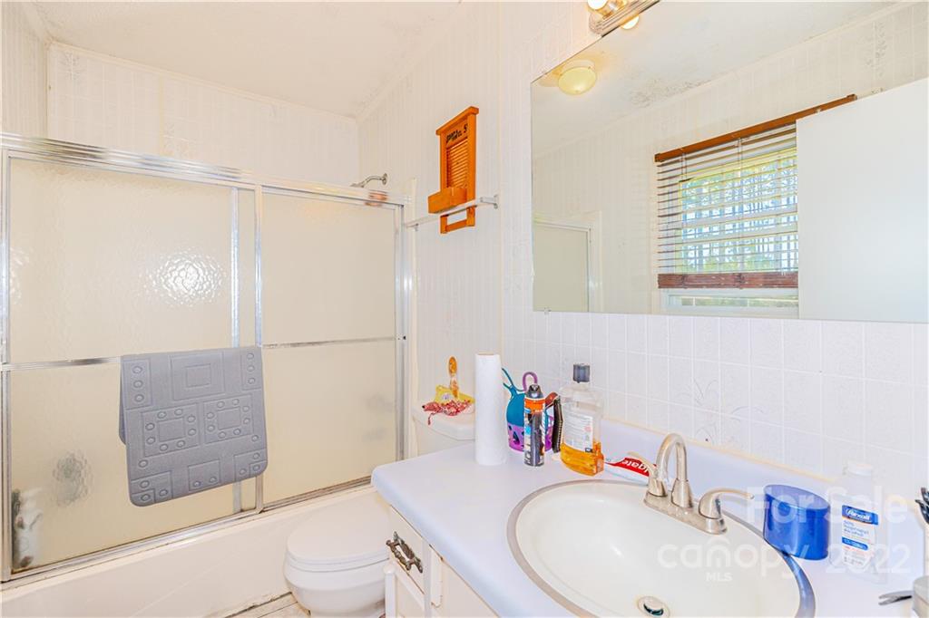 8264 Lockhart Road Sharon, SC 29742 - Photo 11 of 46 a bathroom with a sink vanity mirror and toilet