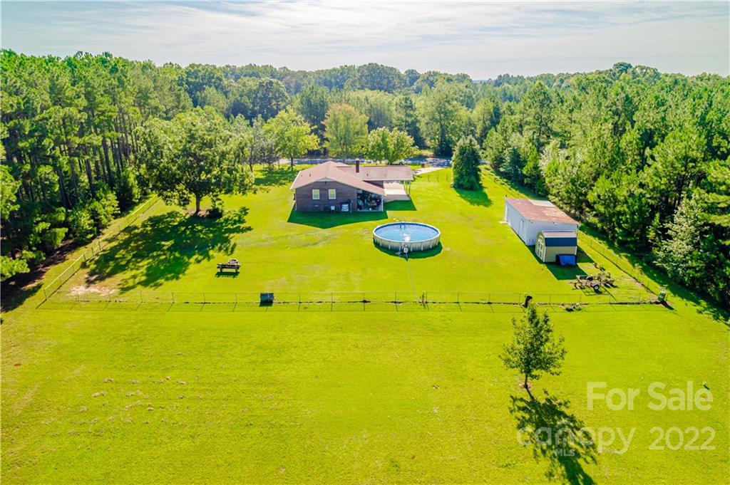 8264 Lockhart Road Sharon, SC 29742 - Photo 18 of 46 a view of a swimming pool with an outdoor space and seating area
