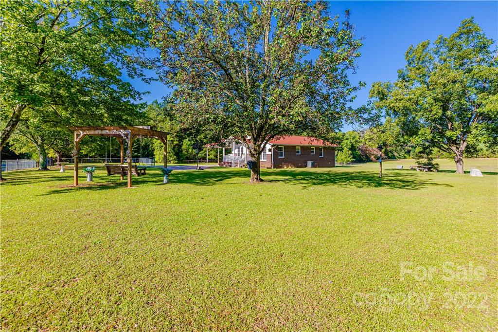 8264 Lockhart Road Sharon, SC 29742 - Photo 36 of 46 a view of a swimming pool with an outdoor space and seating area