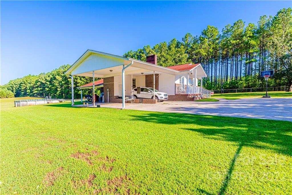 8264 Lockhart Road Sharon, SC 29742 - Photo 4 of 46 a house view with swimming pool and garden space