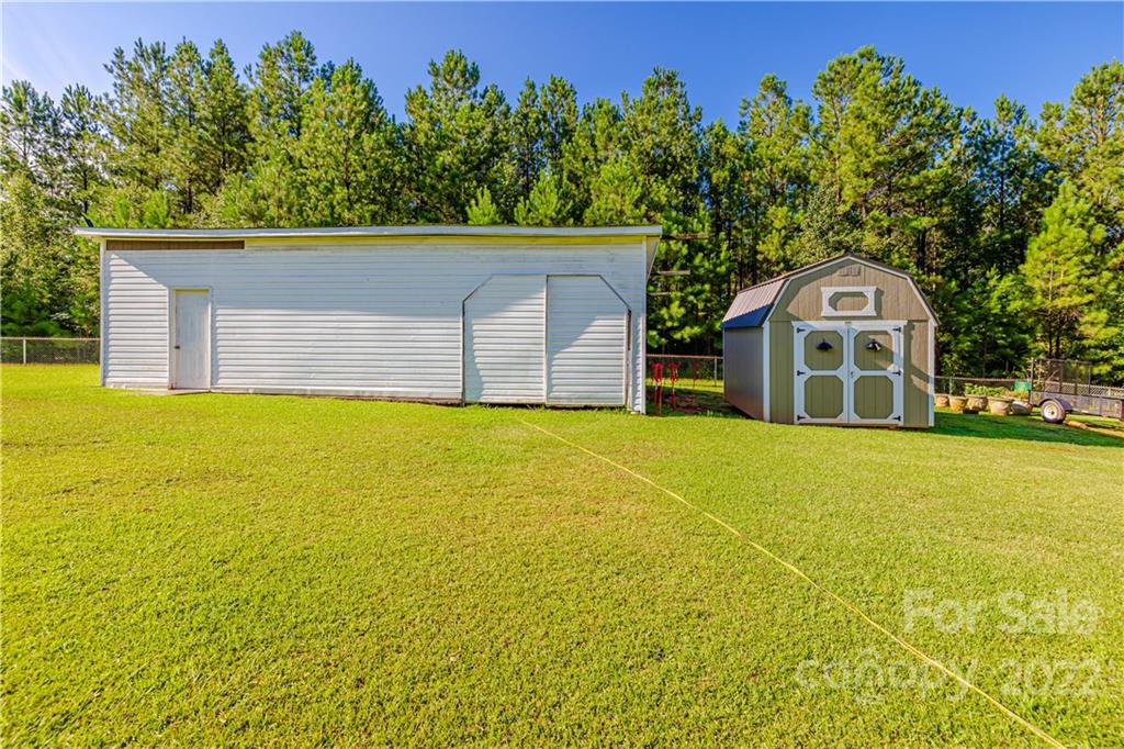 8264 Lockhart Road Sharon, SC 29742 - Photo 41 of 46 a front view of a house with a garden and tree