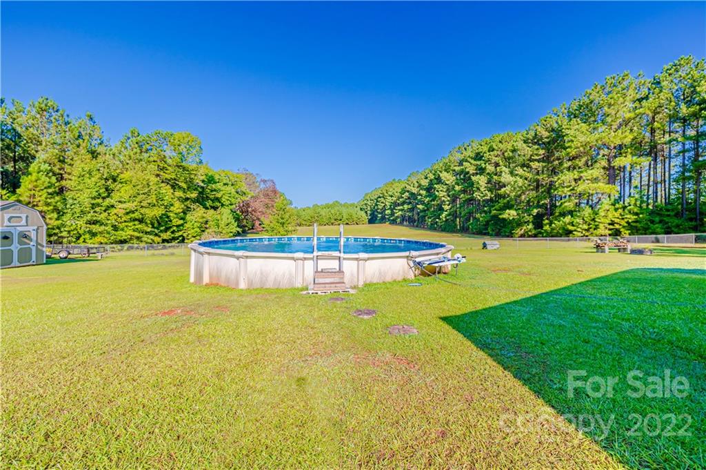 8264 Lockhart Road Sharon, SC 29742 - Photo 43 of 46 a view of a swimming pool with an outdoor space and seating area