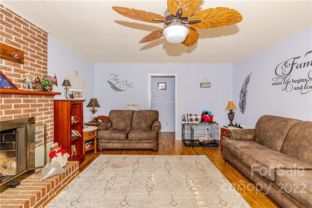 8264 Lockhart Road Sharon, SC 29742 - Photo 6 of 46 a living room with furniture a fireplace and a chandelier