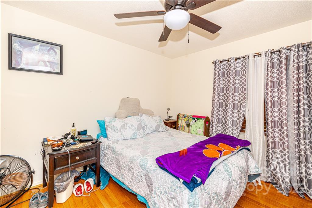 8264 Lockhart Road Sharon, SC 29742 - Photo 10 of 46 a bedroom with a bed and a chandelier