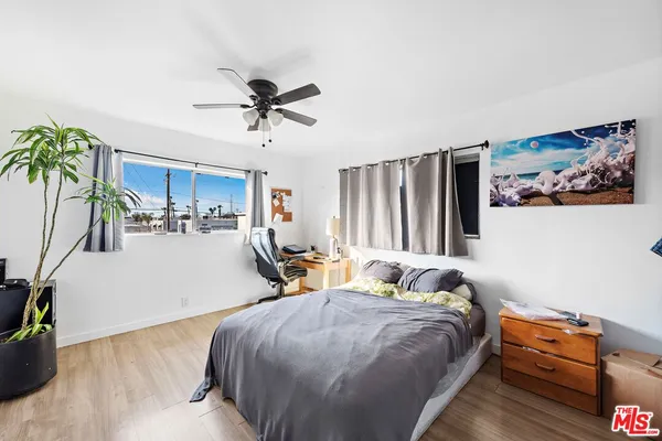a bed room with a bed and a chair
