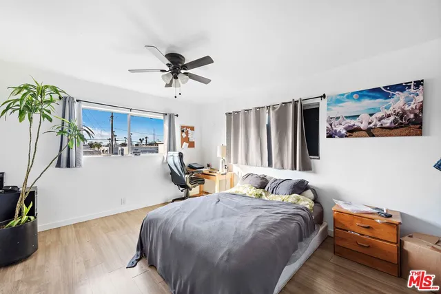 a bed room with a bed and a chair