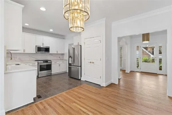 a kitchen with stainless steel appliances granite countertop a refrigerator and a stove top oven
