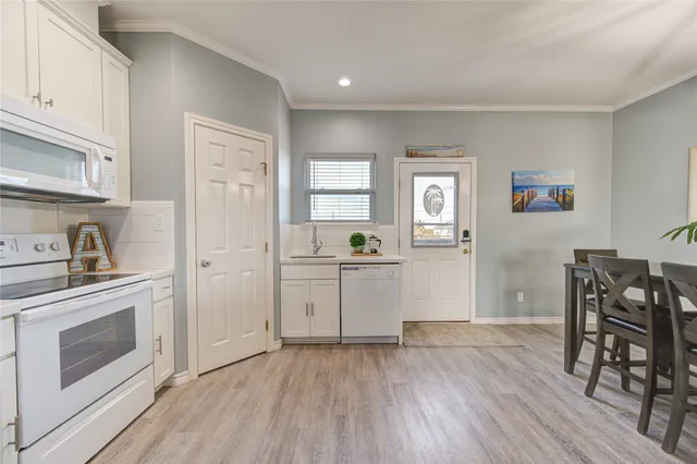 a kitchen with a wooden floor and a stove top oven