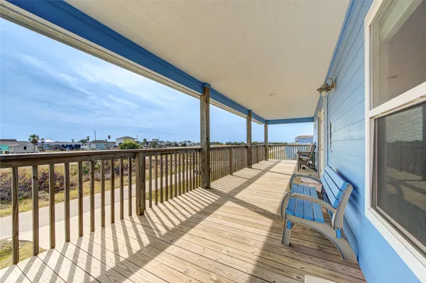 a view of balcony with wooden floor and fence