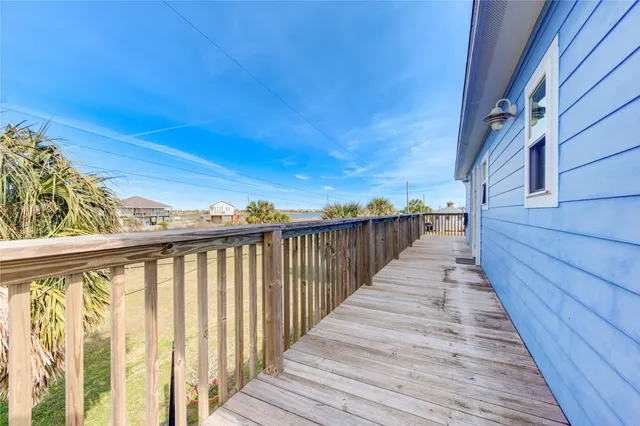 a view of balcony with wooden floor and fence