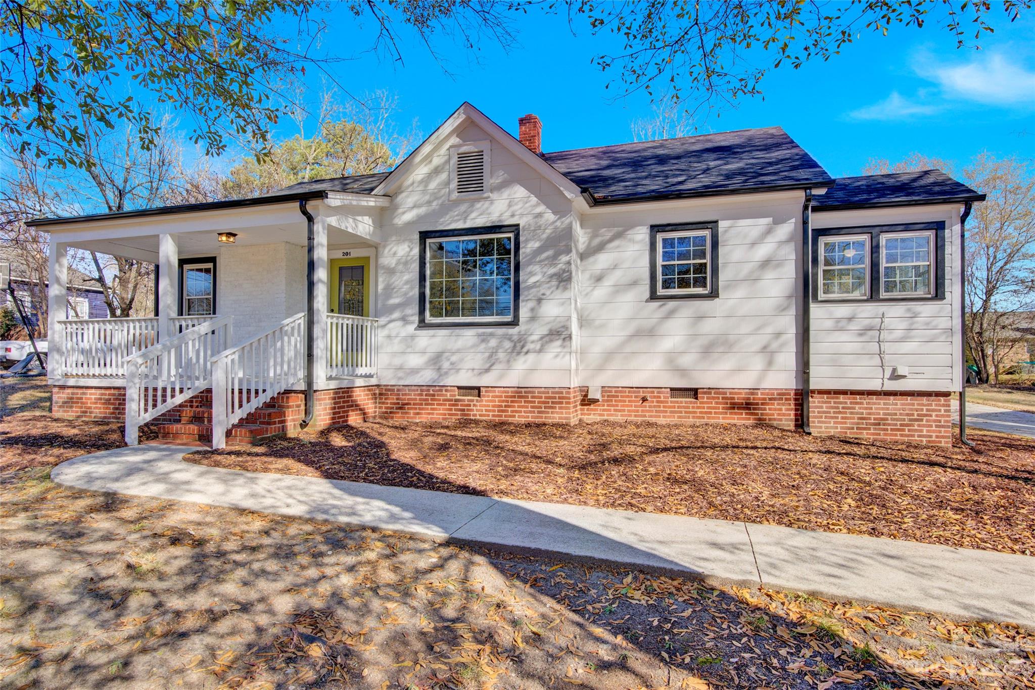201 Knox Street Clover, SC 29710 - Photo 1 of 34 a front view of a house with a garden