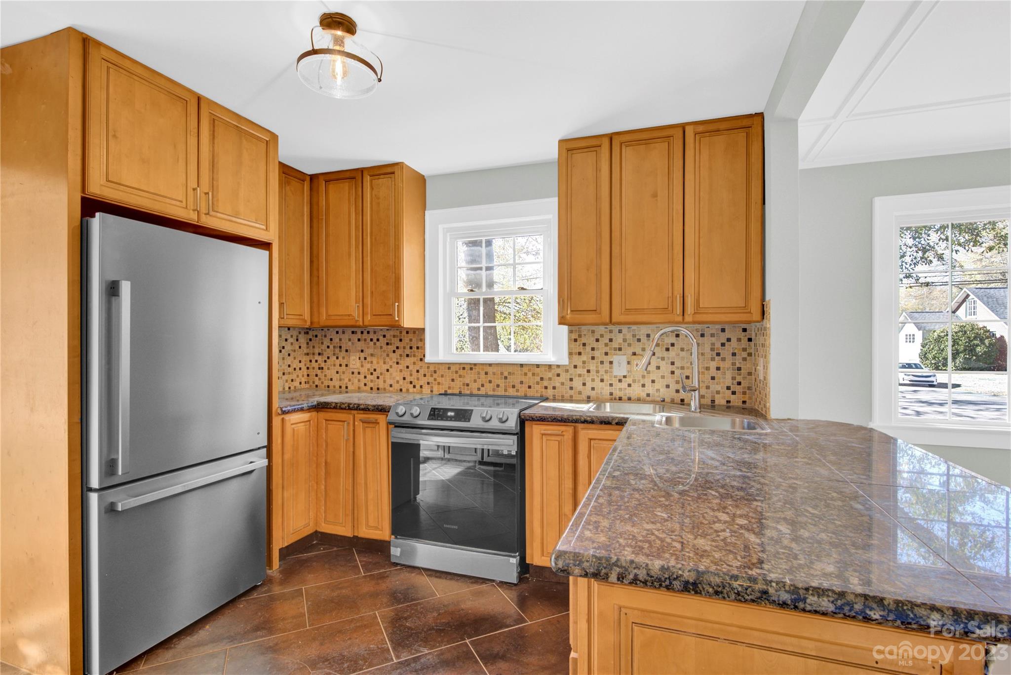 201 Knox Street Clover, SC 29710 - Photo 12 of 34 a kitchen with granite countertop stainless steel appliances a refrigerator a sink a stove cabinets and living room view