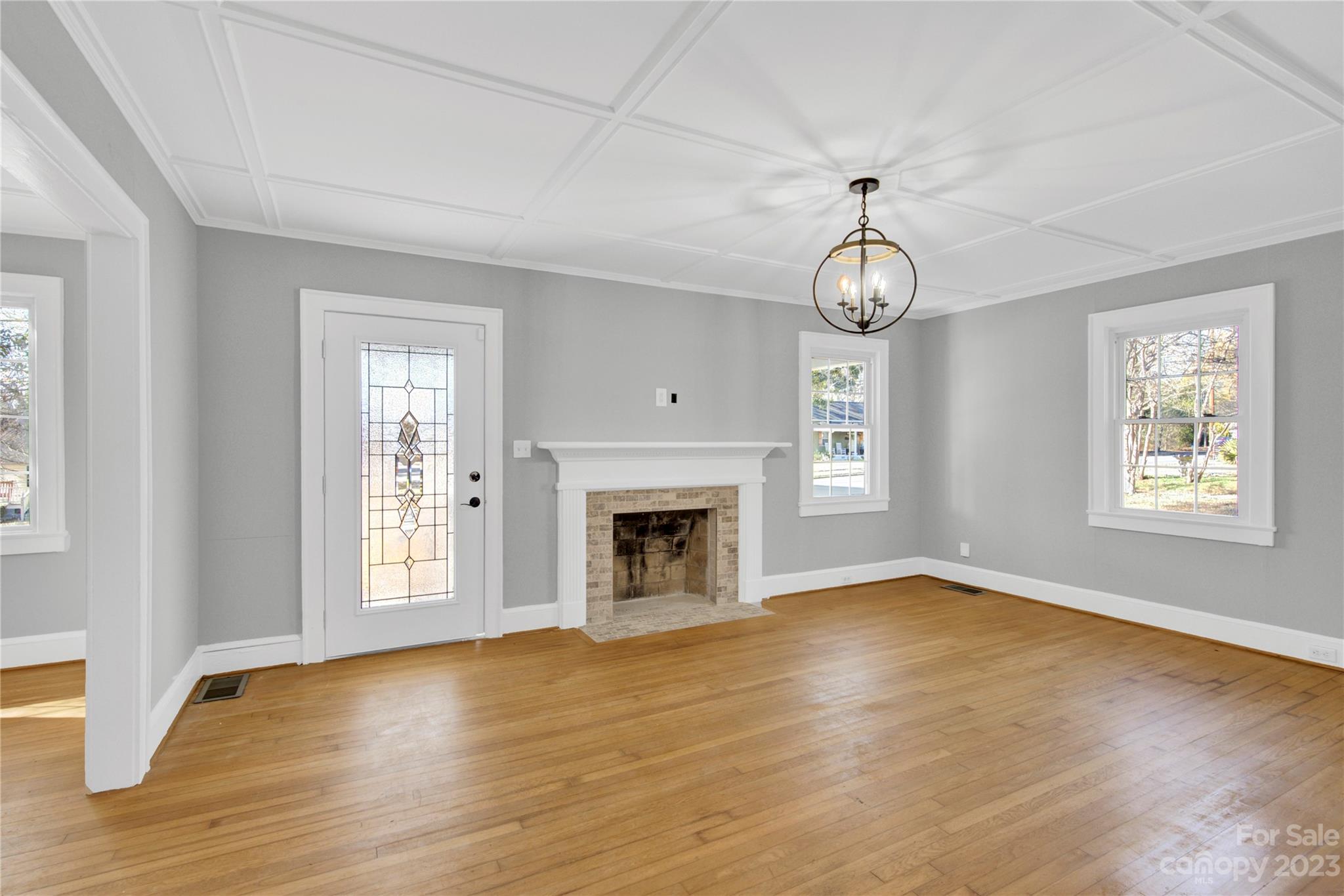201 Knox Street Clover, SC 29710 - Photo 5 of 34 a view of an empty room with wooden floor fireplace and a window
