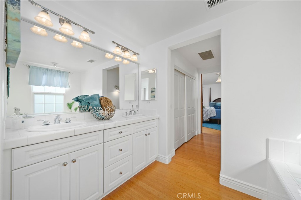 40 Waterspout Irvine, CA 92620 - Photo 25 of 40 a spacious bathroom with a granite countertop sink mirror and shower