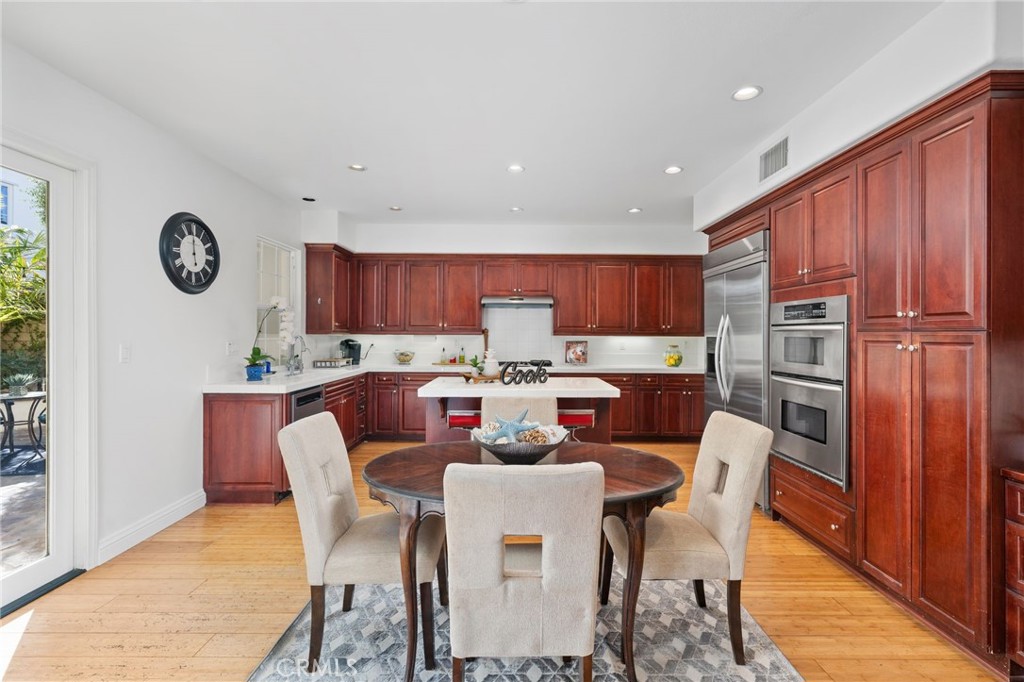 40 Waterspout Irvine, CA 92620 - Photo 8 of 40 a kitchen with a dining table chairs and refrigerator