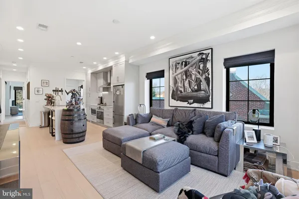 a living room with furniture and floor to ceiling windows