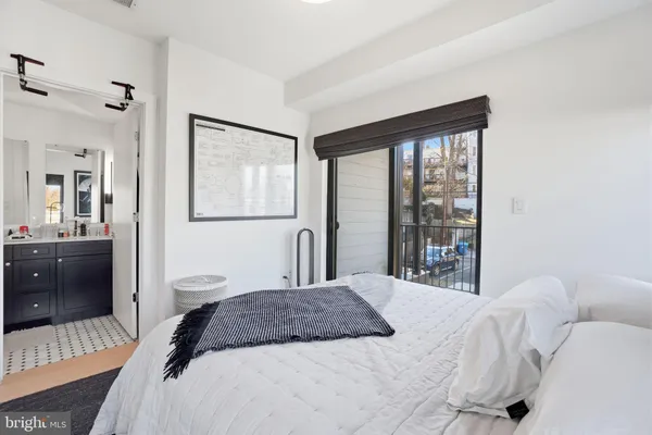 a bedroom with a large bed and a large mirror