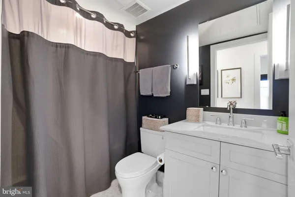 a bathroom with a toilet a sink and a mirror