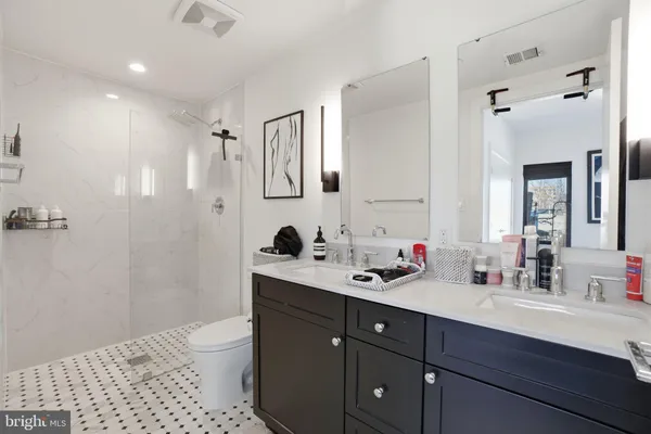 a bathroom with a bathtub sink vanity and a shower