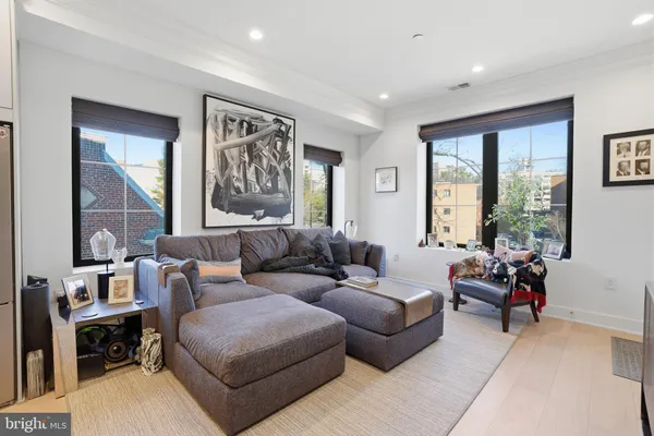 a living room with furniture and large windows