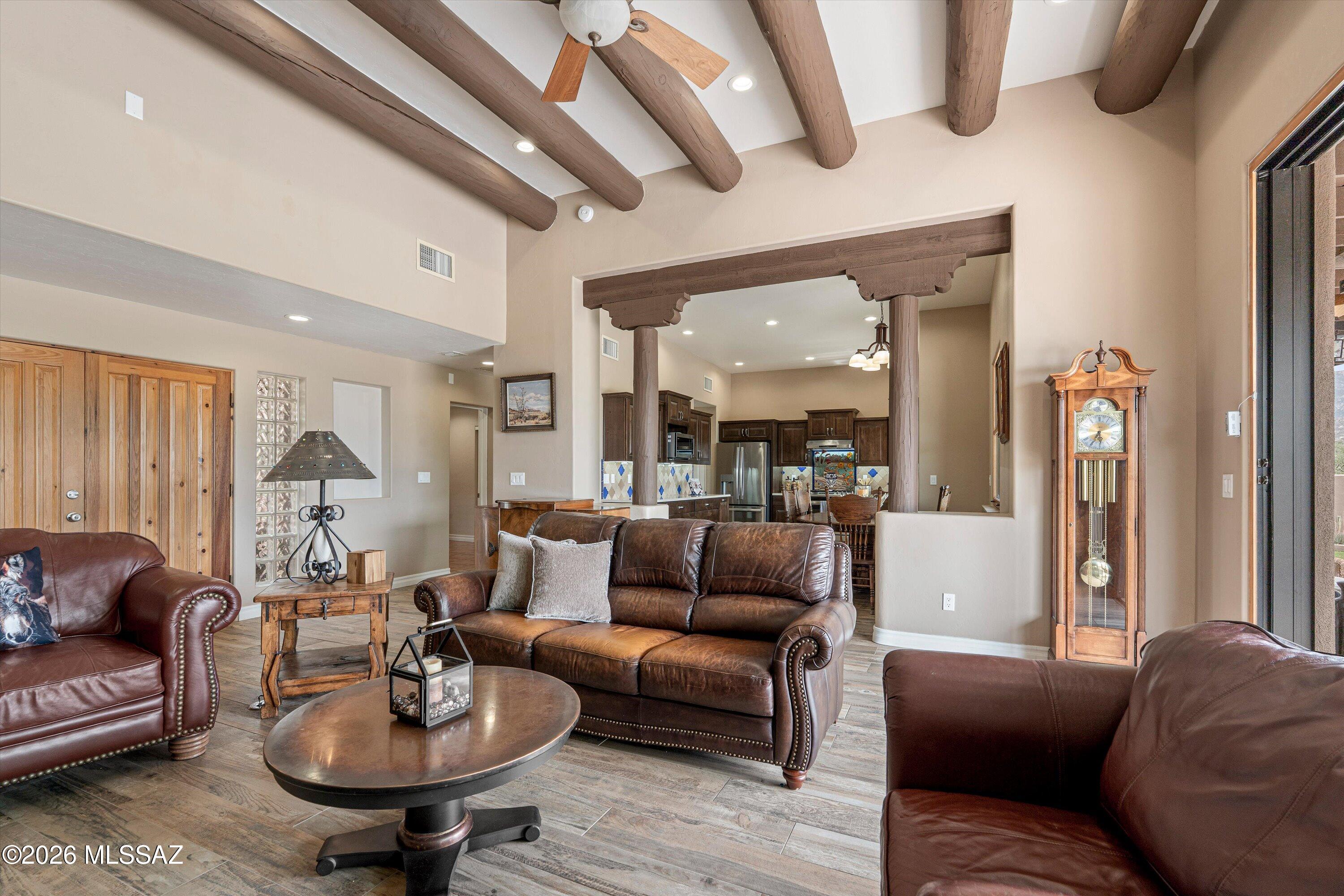 4760 East Wagon Train Road Tucson, AZ 85739 - Photo 20 of 38 a living room with furniture and a wooden floor