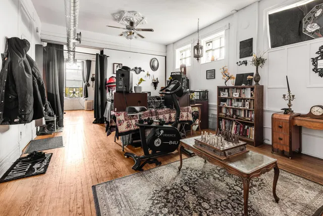 a living room with furniture a flat screen tv and a table
