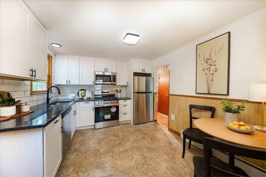 17 Coolidge Street Billerica, MA 01821 - Photo 11 of 32 a kitchen with granite countertop a refrigerator stove top oven and sink